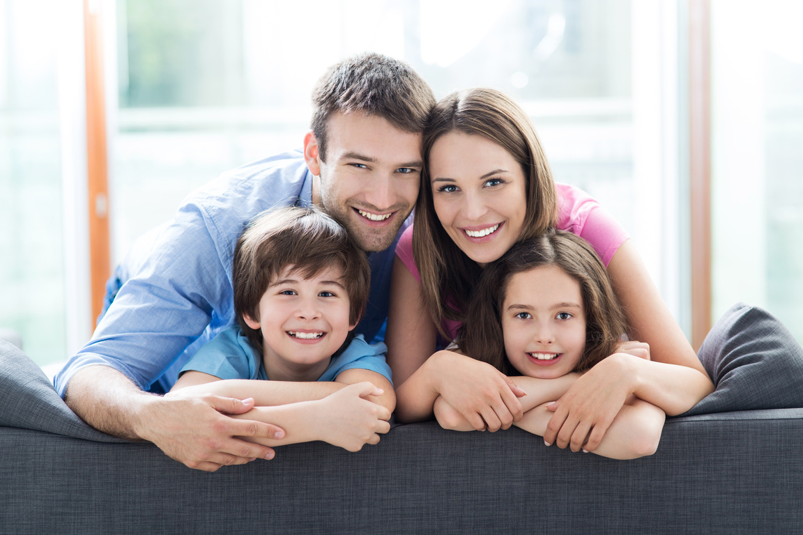 Smiling family on sofa